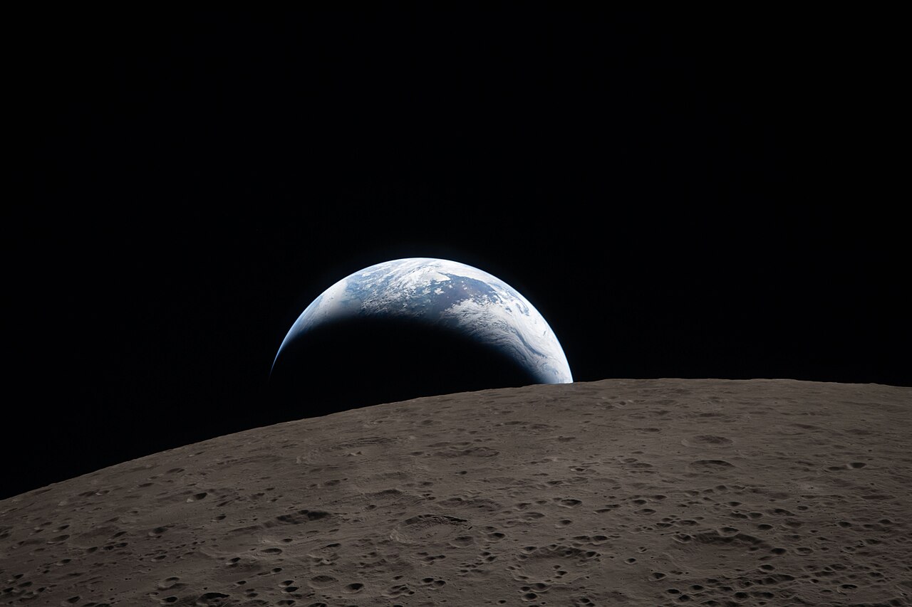Earth setting below the lunar horizon, photographed from Orion during Artemis II